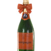 Decorative champagne bottle ornament with a bow on a white background