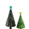 Two decorative Christmas trees, one dark pine green and one green, on a white background.