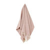 Pink herringbone blanket draped over a white background