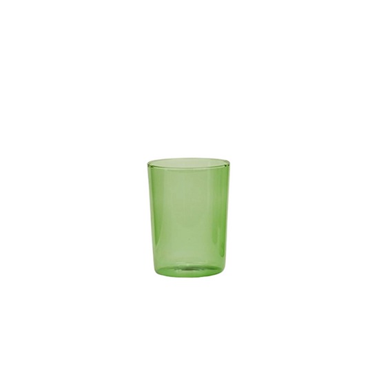 Green glass tumbler on a white background