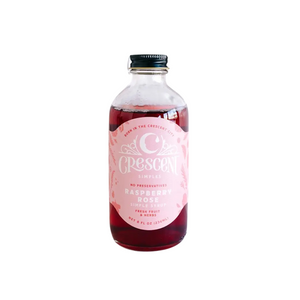 Bottle of Raspberry Rose Syrup on a white background