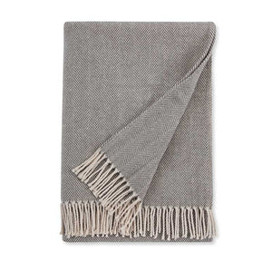 Gray herringbone patterned throw blanket with fringed edge on a white background