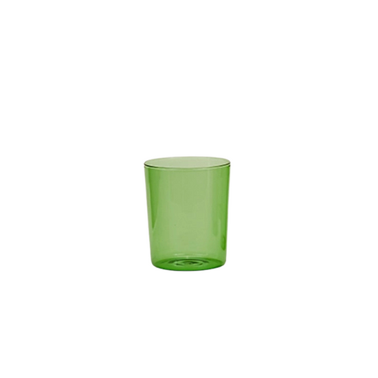 Green glass tumbler on a white background