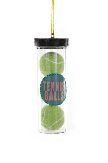 Clear container with two green tennis balls and a label on a white background