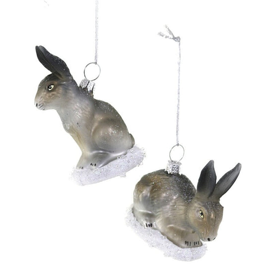 Two glass bunny ornaments, hanging against a white background.