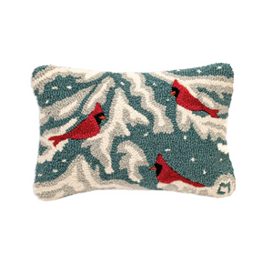 Rectangular decorative throw pillow featuring a textured, tufted winter scene with red cardinals on a snowy landscape. The design has a teal blue-green background, cream-colored snow, and red birds with black details, shown against a plain white background.